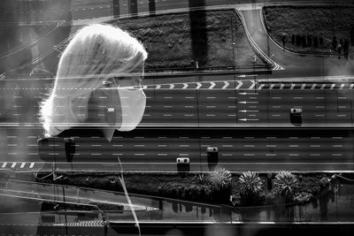 Rear view of woman on glass window of train