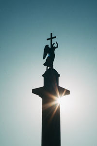 Low angle view of silhouette statue against sky during sunset