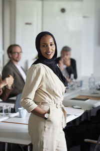 Smiling businesswoman in boardroom