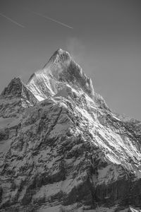 Low angle view of snowcapped mountain against sky