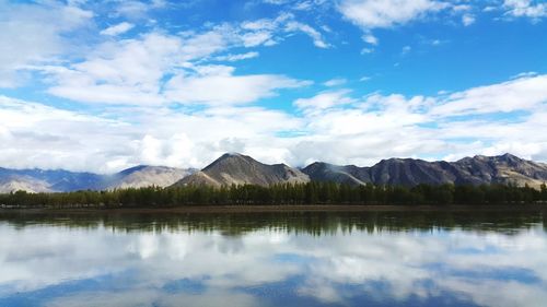 Scenic view of lake and mountains against sky