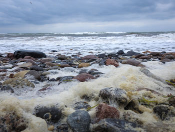 Rocks on beach against sky