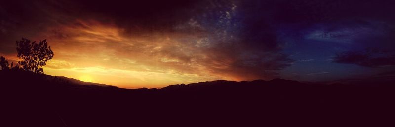 Silhouette of mountain against sky at sunset