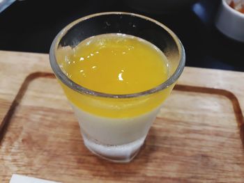 High angle view of yellow drink on table