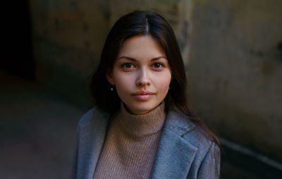 Portrait of beautiful young woman standing outdoors