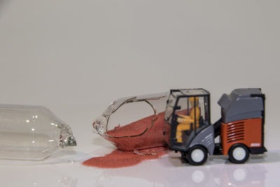 Close-up of car on table against white background