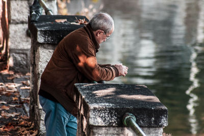 Side view of man looking at camera