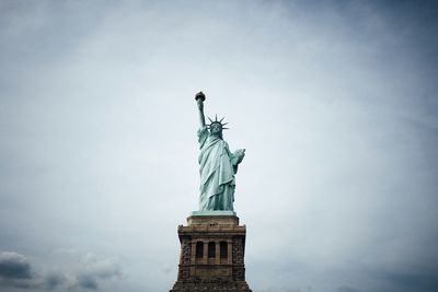 Statue of liberty against cloudy sky