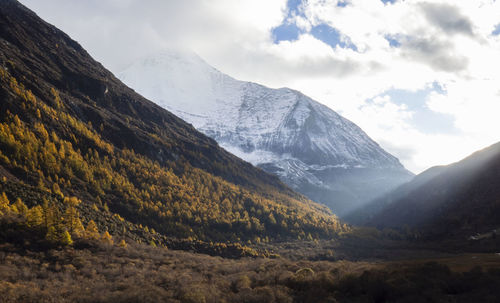 Scenic view of mountains against cloudy sky