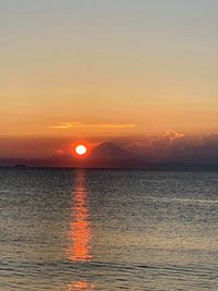 Scenic view of sea against romantic sky at sunset