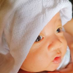 Close-up of cute baby boy looking away