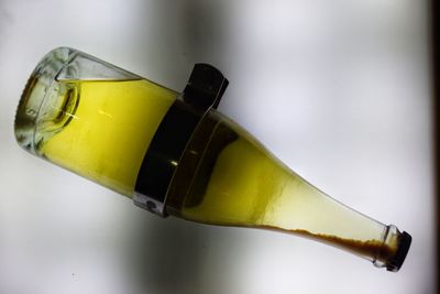 Close-up of drink on table against white background