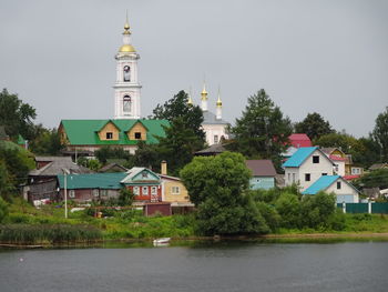 View of buildings and trees against sky