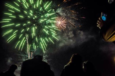 Low angle view of firework display at night