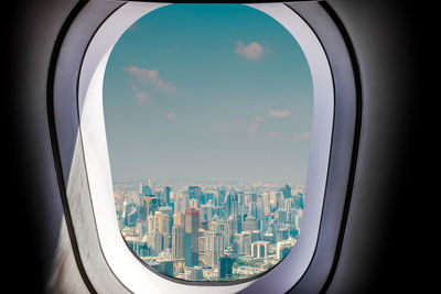 Aerial view of cityscape seen through airplane window