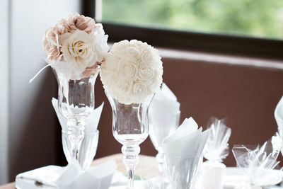 Close-up of white roses in vase on table