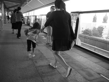 Rear view of people at subway station