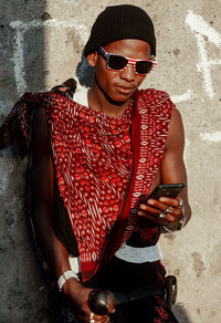 Young man wearing sunglasses while standing outdoors