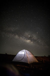 Tent on land against sky at night