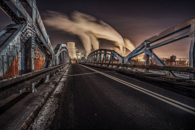 Bridge in city against sky during dusk