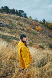 Side view of woman standing on field