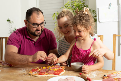 Portrait of a smiling girl with food on table