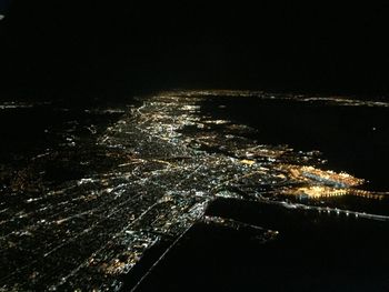 Aerial view of illuminated city at night