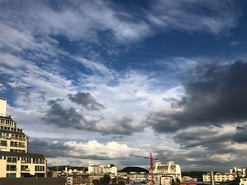 Low angle view of buildings against cloudy sky