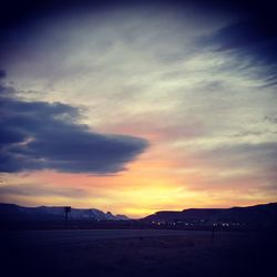 Scenic view of mountains against cloudy sky