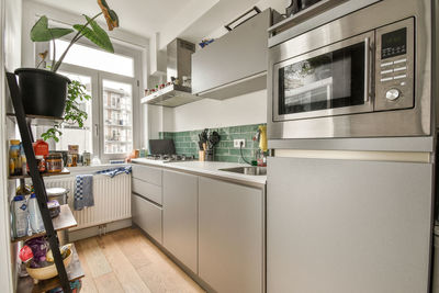 Portrait of woman sitting in kitchen