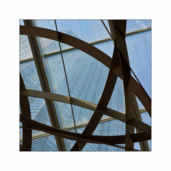 Low angle view of modern building against clear blue sky