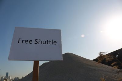 Low angle view of information sign against sky