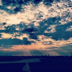 Scenic view of landscape against cloudy sky