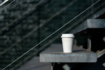 Close-up of disposable cup on staircase