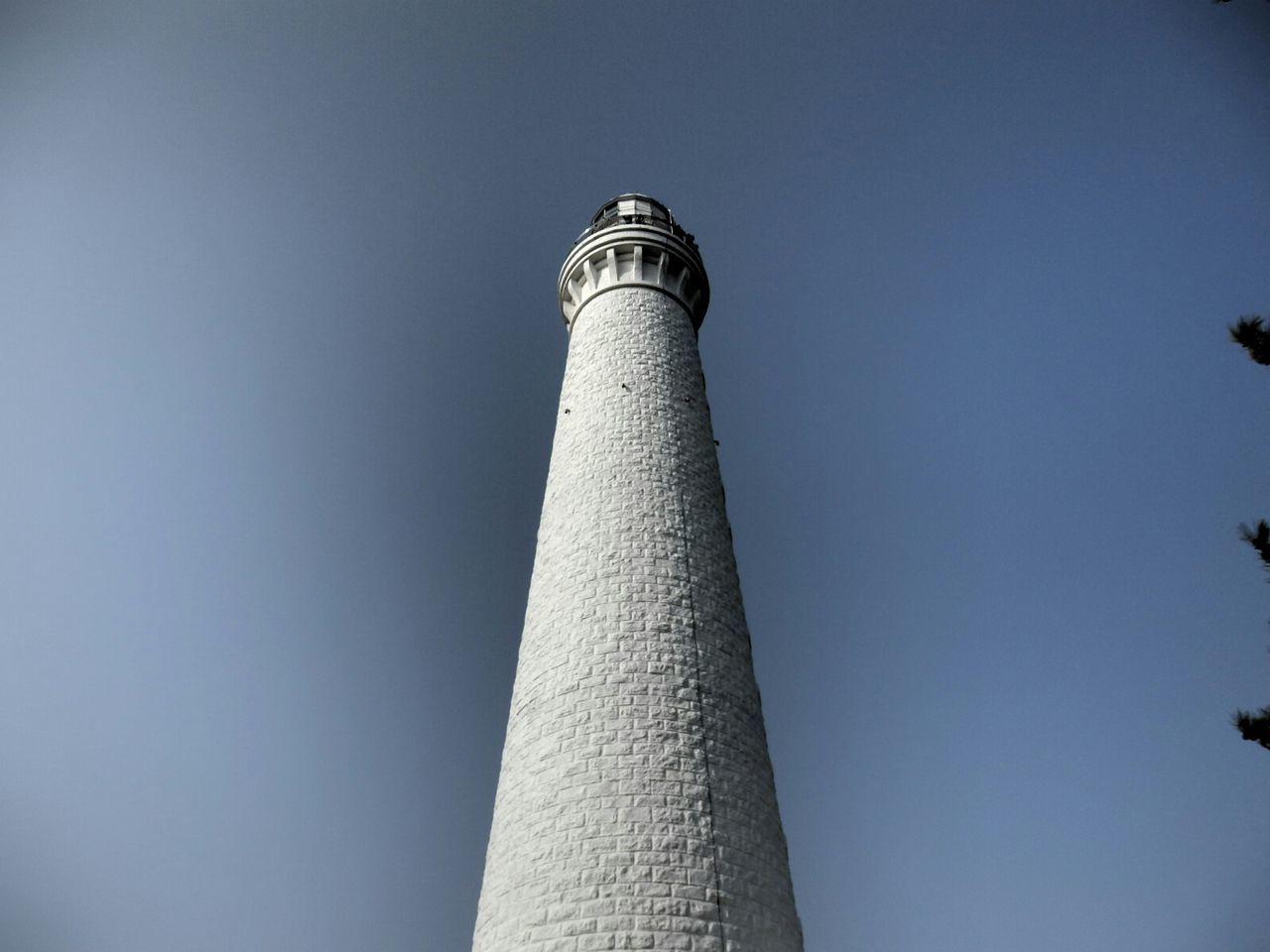 architecture, low angle view, built structure, tower, building exterior, tall - high, clear sky, lighthouse, guidance, blue, copy space, direction, tall, travel destinations, sky, smoke stack, communications tower, famous place, travel, no people