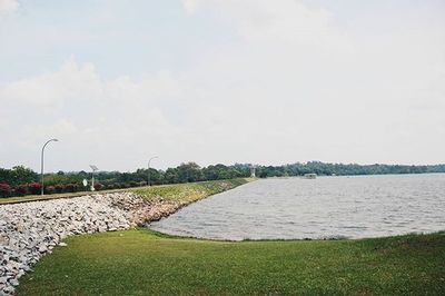 Scenic view of river against cloudy sky