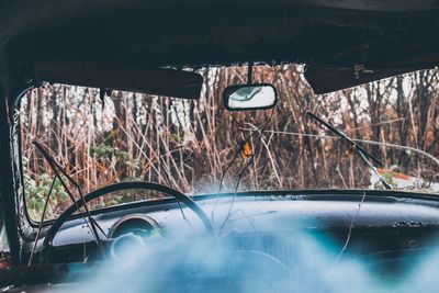 Close-up of abandoned car on field