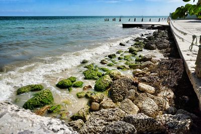 View of sea with rocky shore by promenade