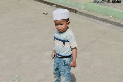 Portrait of boy standing on road