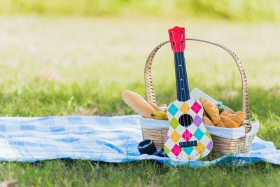 Close-up of wicker basket on field