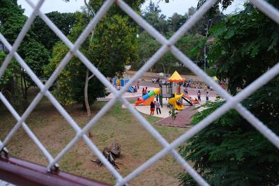 People playing seen through chainlink fence