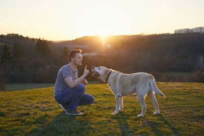 Man playing with dog on grass