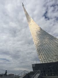 Low angle view of modern building against cloudy sky