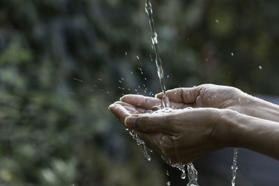 Water falling on hands