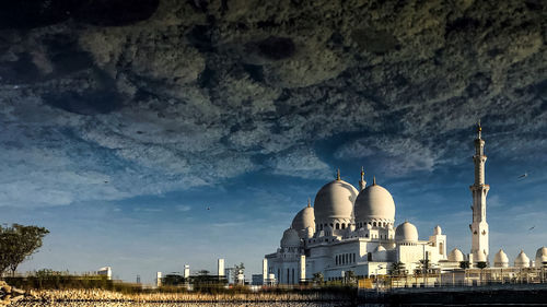 Reflection of sheikh zayed mosque on puddle