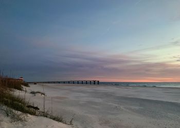 Scenic view of beach against sky during sunset