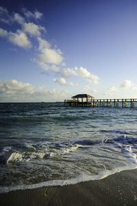 Scenic view of sea against cloudy sky