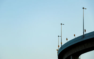 Low angle view of bridge against clear blue sky