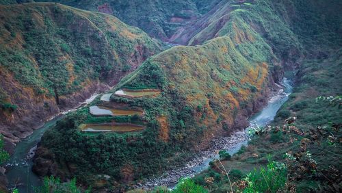 High angle view of stream amidst land