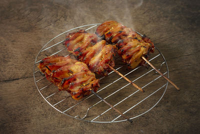 High angle view of meat on barbecue grill